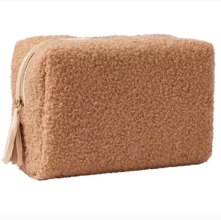 faux shearling pouch featuring a rectangle-shaped body and a zippered top handle