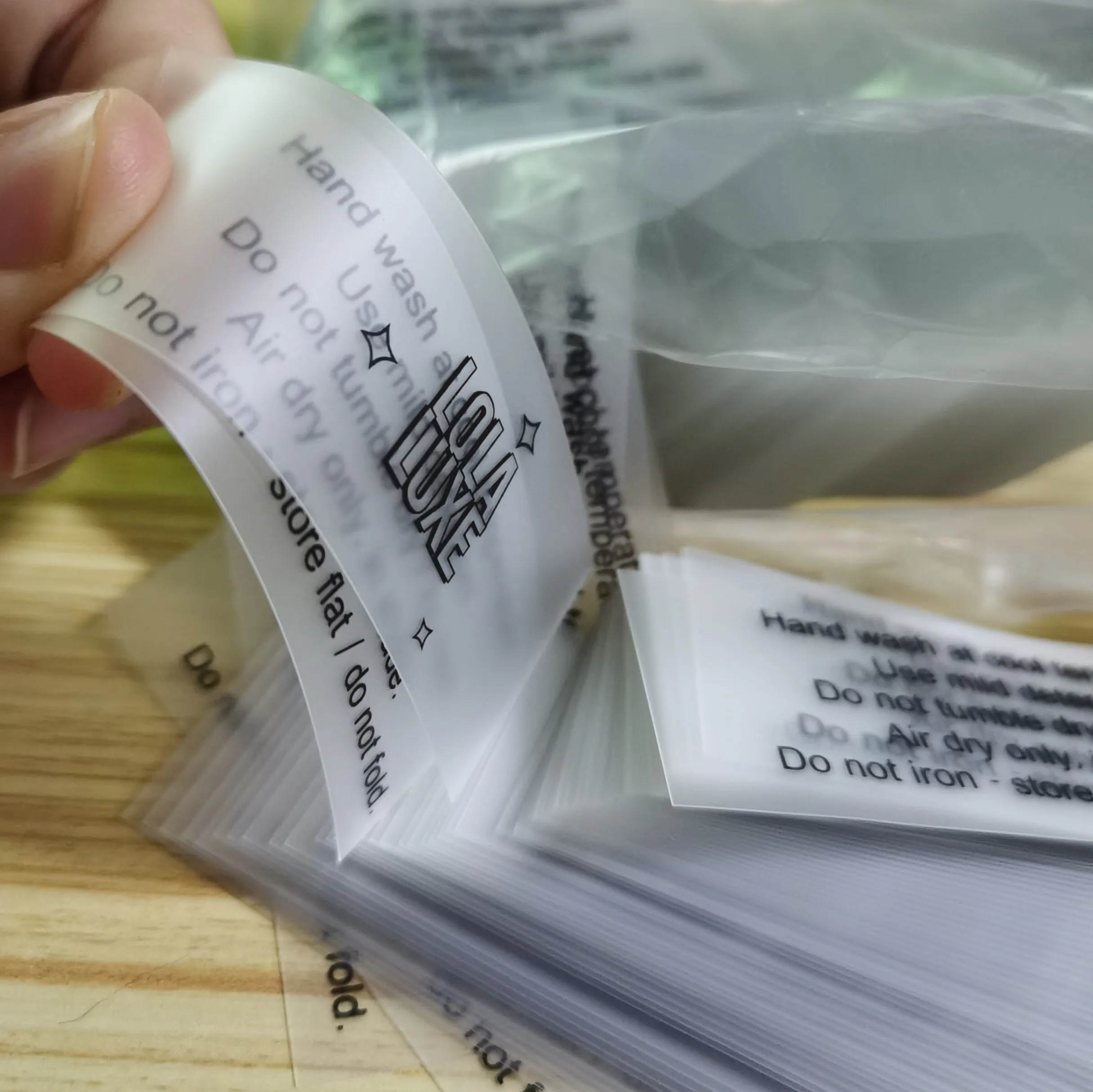 
Garment underwear size custom printed clear TPU sewn tag with logo and care symbol 