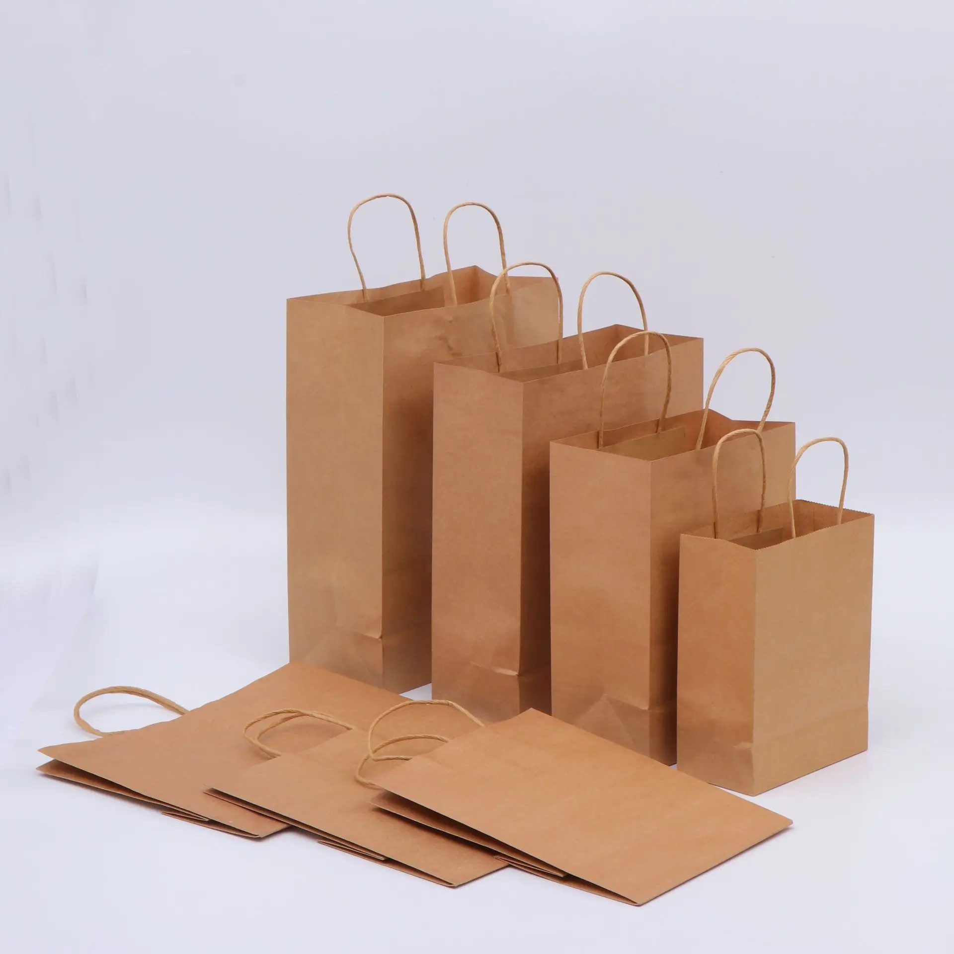 Cheap recyclable  Kraft paper bags brown Kraft paper bags white Kraft paper bags with twisted hand ropes