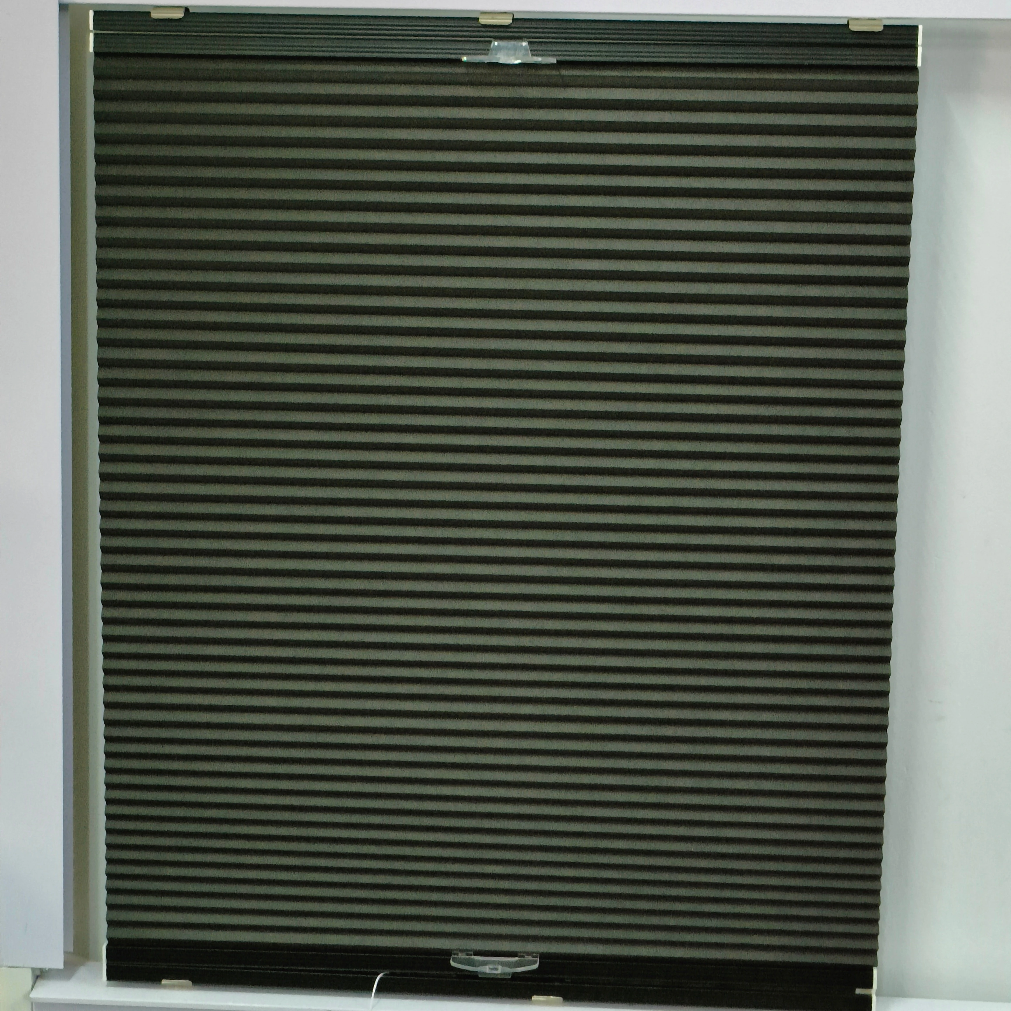 Cordless black color blackout cellular blind