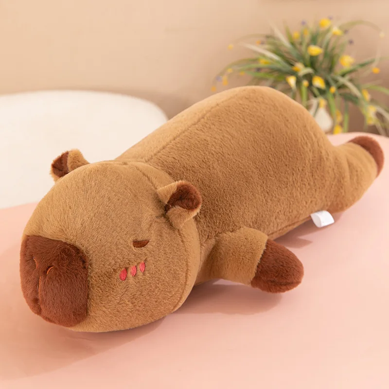 The capybara pulls the pillow for girls to sleep on the bed and holds the sleeping doll long pillow plush toy