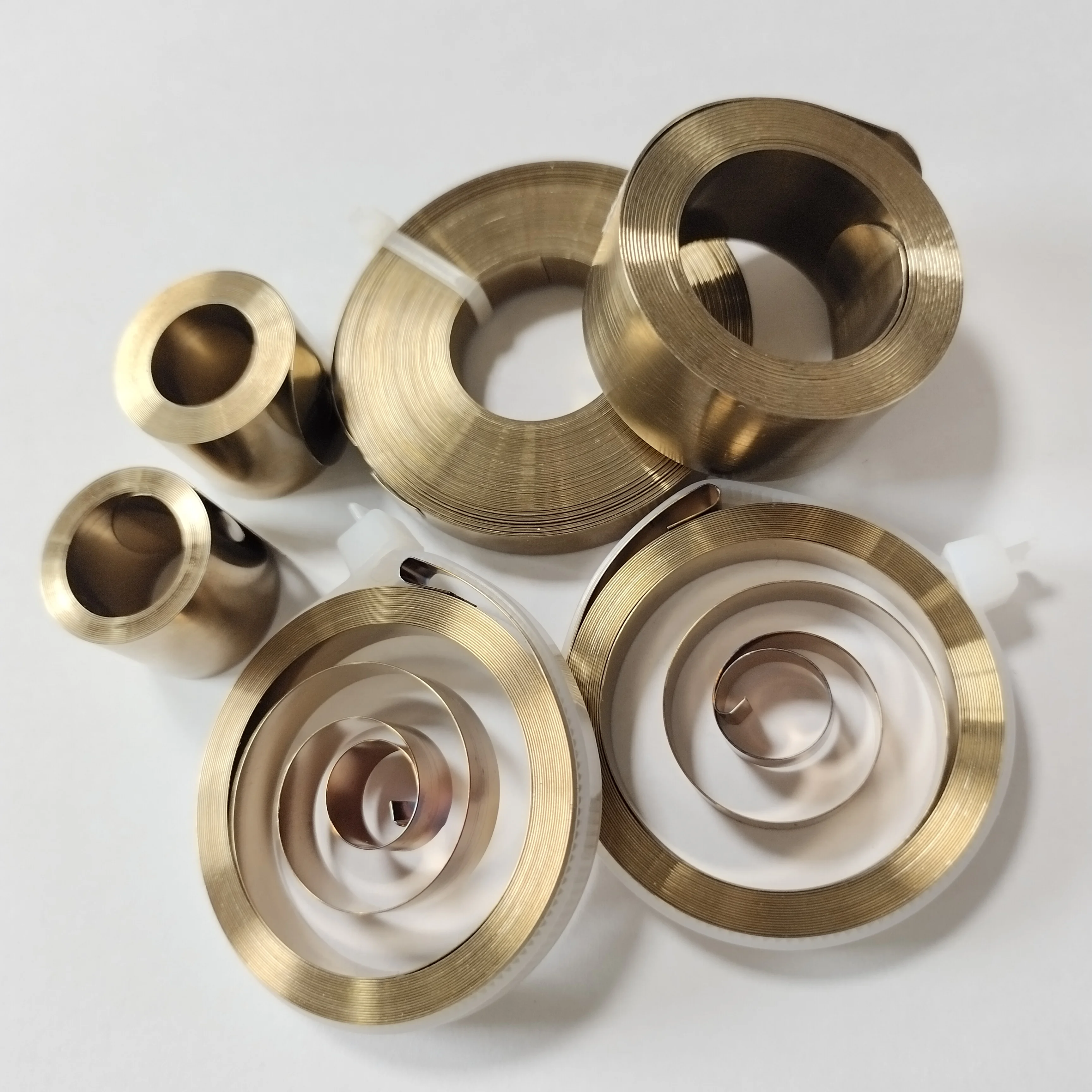 Expert Manufacturer Retractable Cable Reel Flat Coil Wind Up Rewind Spiral Torsion Power recoil spring used in a rowing machine