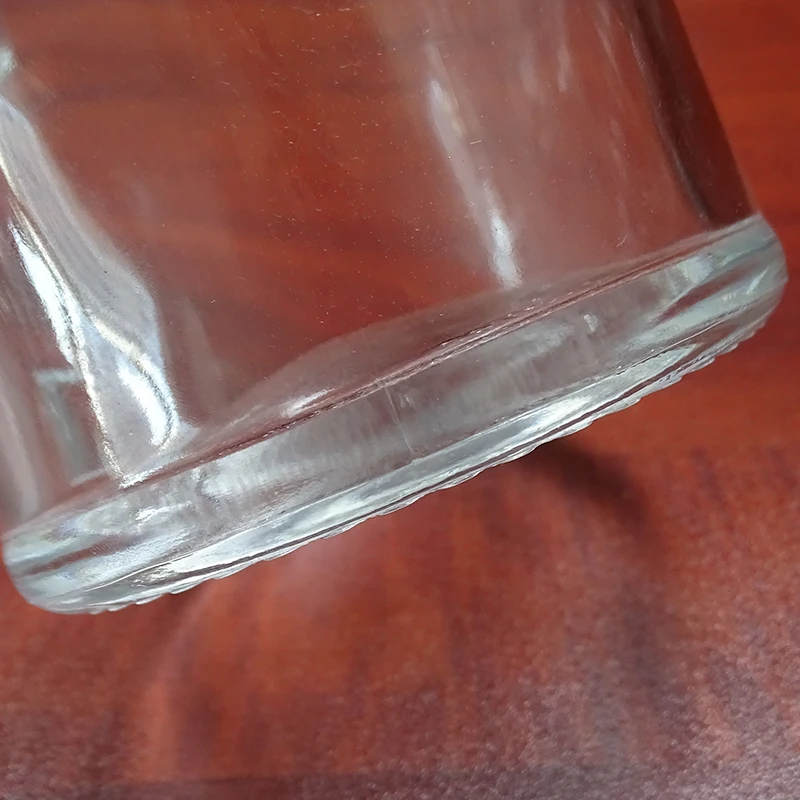 embossed custom brand cheap 1l glass bottle round for whiskey alcohol