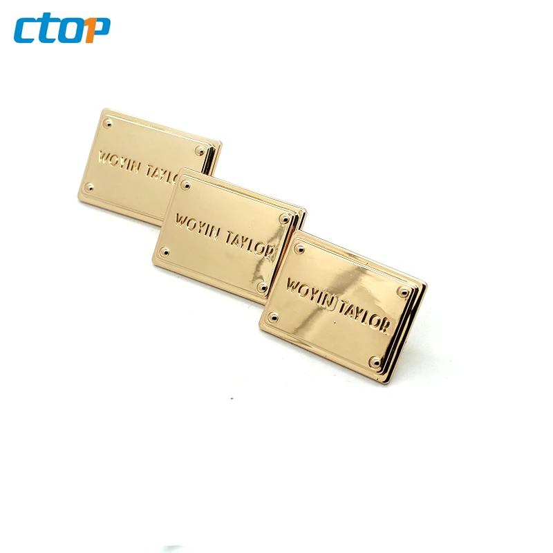 Wholesale standard environmental custom embossed metal logo plate bags metal labels for clothing