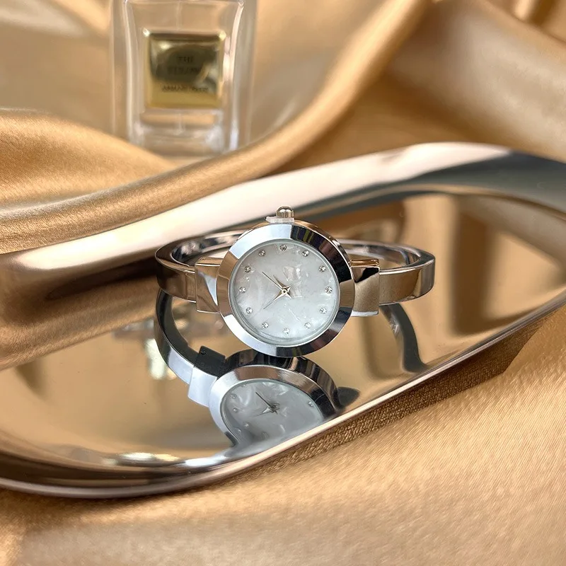 Hot selling mother of pearl dial zinc alloy case and band quartz movement fashion design for lady gold bangle watches women