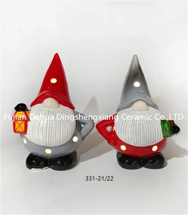 Hand-painted ceramic gnome santa claus with present for holiday decoration