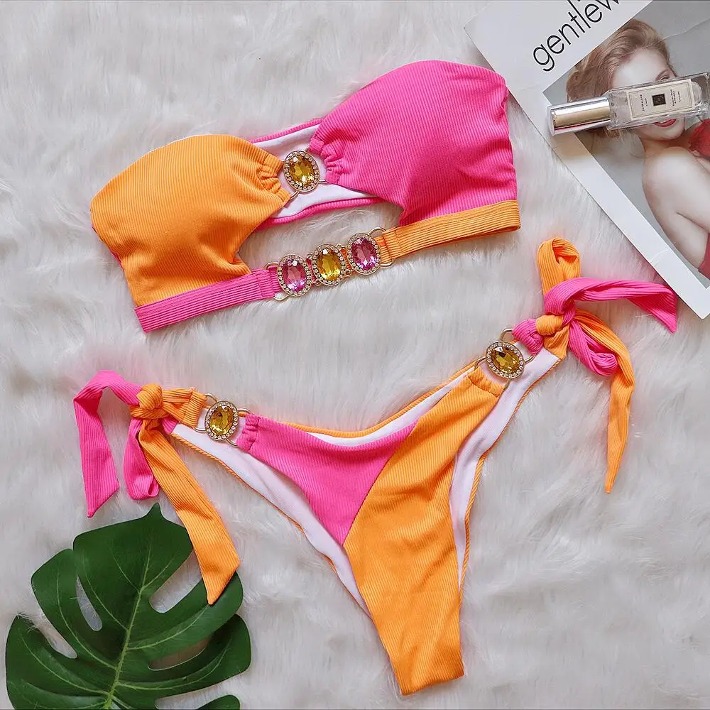 Hot girl in sexy bikini with young girl. Body chain jewelry in color block contrast color bikini strapless bandeau swimsuit