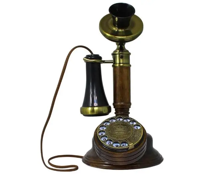 The Old-Fashioned Wall-Mounted Wooden Retro Telephone with Metal Parts with Vintage Rotary Dial and Metal Bell
