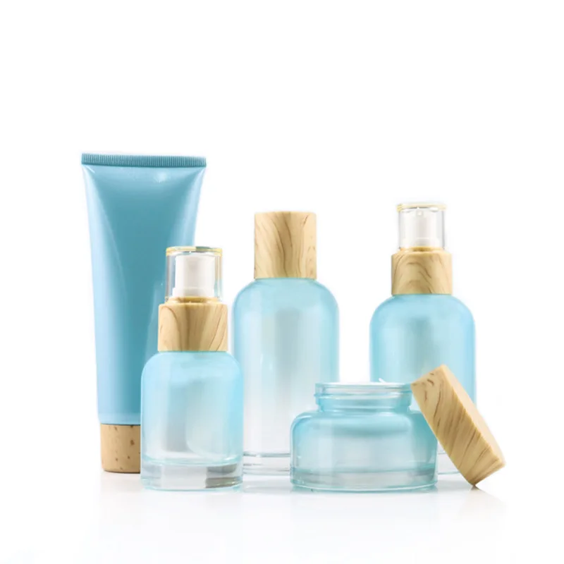 Wholesale High-grade luxurious blue glass cosmetic bottle and jar with bamboo caps 120ml 100ml 40ml 50g cosmetic container pack