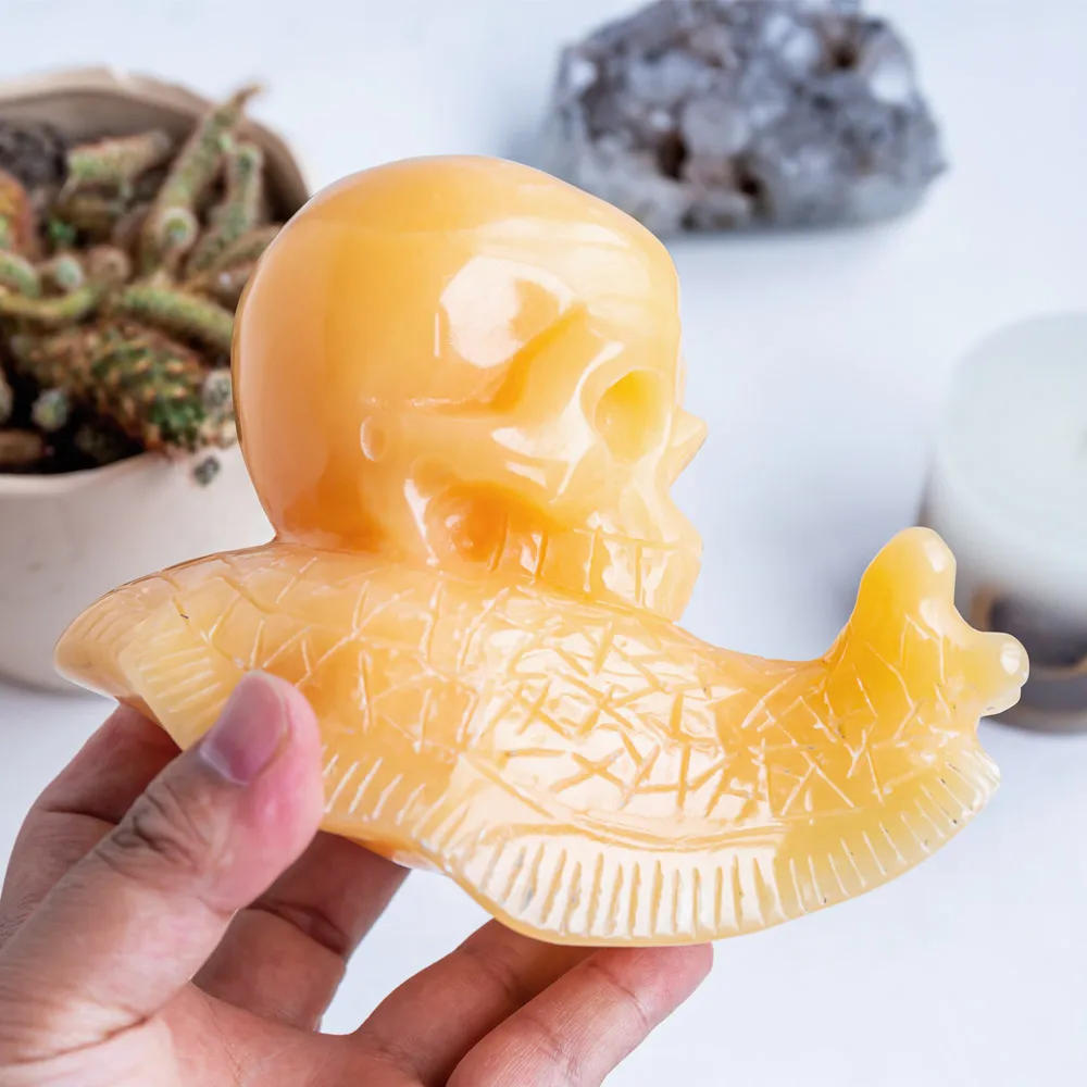 Wholesale hand carved natural healing stone pretty animal orange calcite crystal snail skulls folk crafts for home decoration