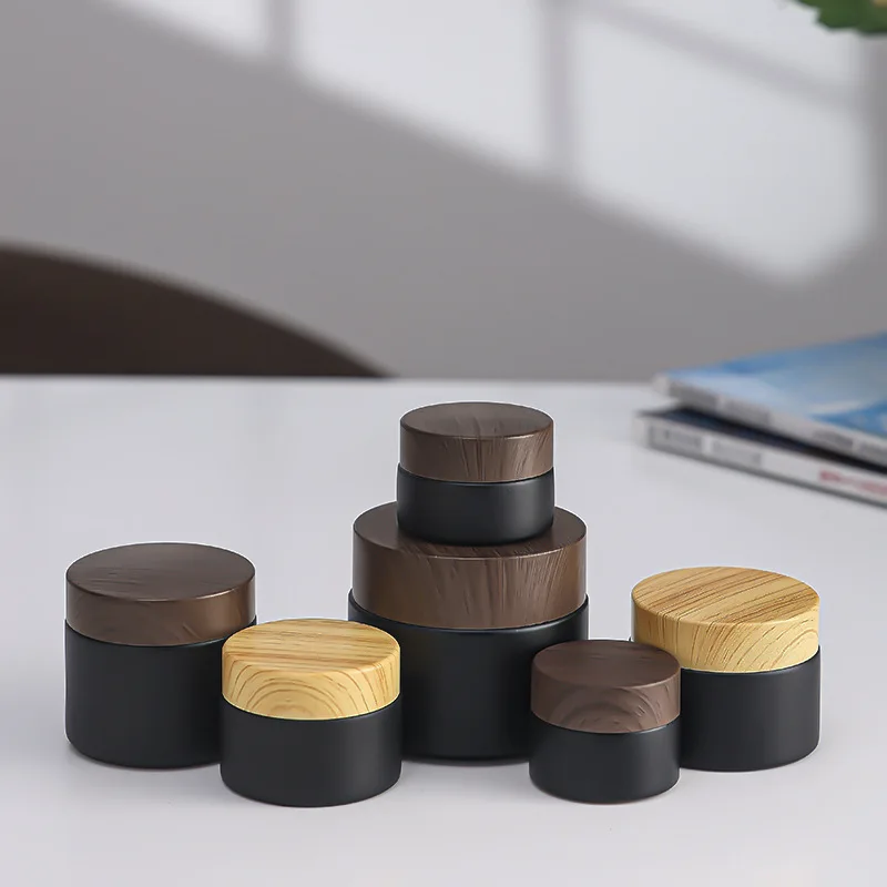 Wholesale 20g 30g 50g 80g 100g Cream Matte Black Glass Jar with New Wood Grain Cover Facial Cream Bottle