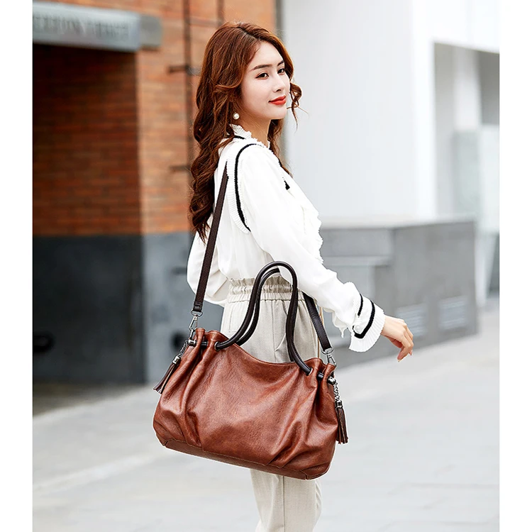 Trendy designer guangzhou retro ladies purses and handbags elegant Black women soft leather cheap handbag bags with tassel