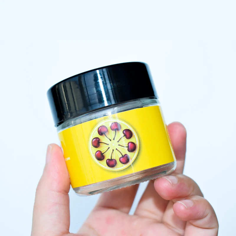 
Custom Design Food Clear Round Glass Jar For Weeds Herbs Skin Cream Bottle With Black Lid 2 Oz 