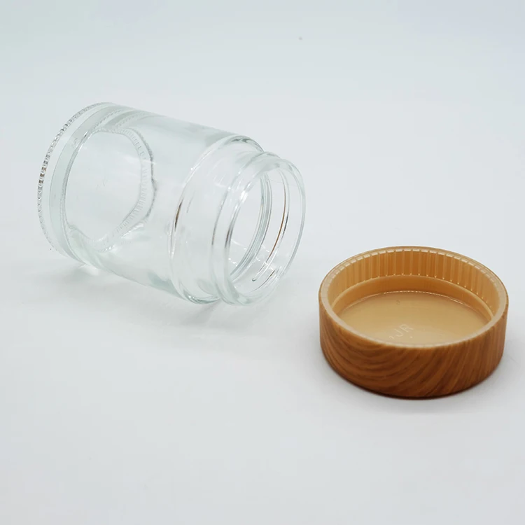 High-End Cylinder Straight Plastic Cap No Leak Heavy Duty Glass Bottle 750ML Clear Glass Jar Bottle With Wood Grain Lid