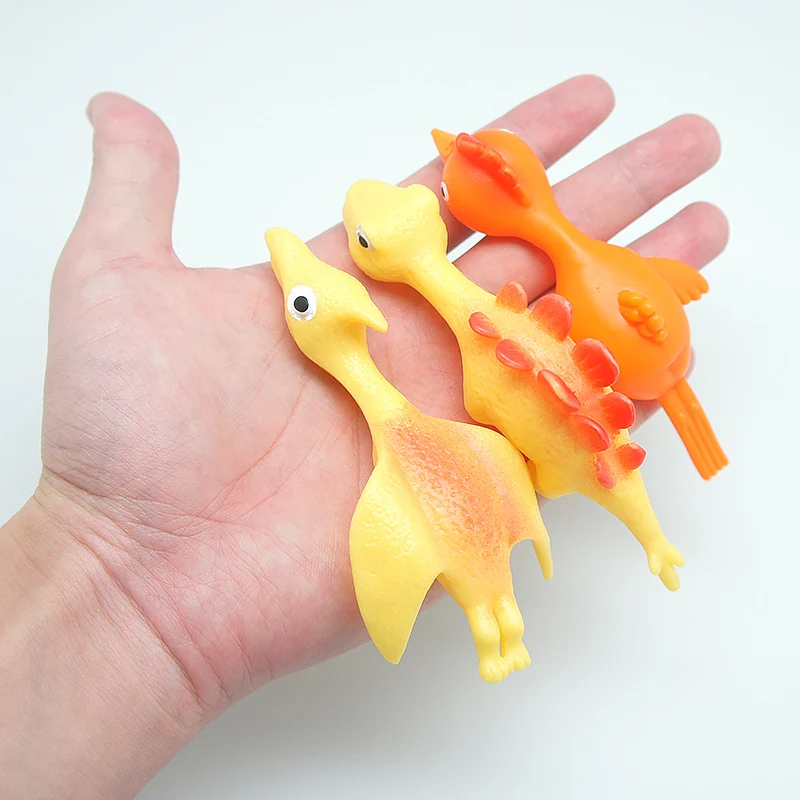 Hot Sale TPR Material High Quality Promotion TPR Dinosaur Toy Slingshot Catapult Toys Small Children Toys