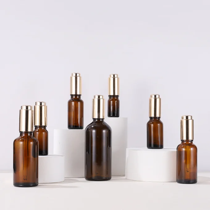 Wholesale empty bottles 20ml 30ml 50ml 100ml gold lotion pump glass essential oil bottle amber cosmetic packaging