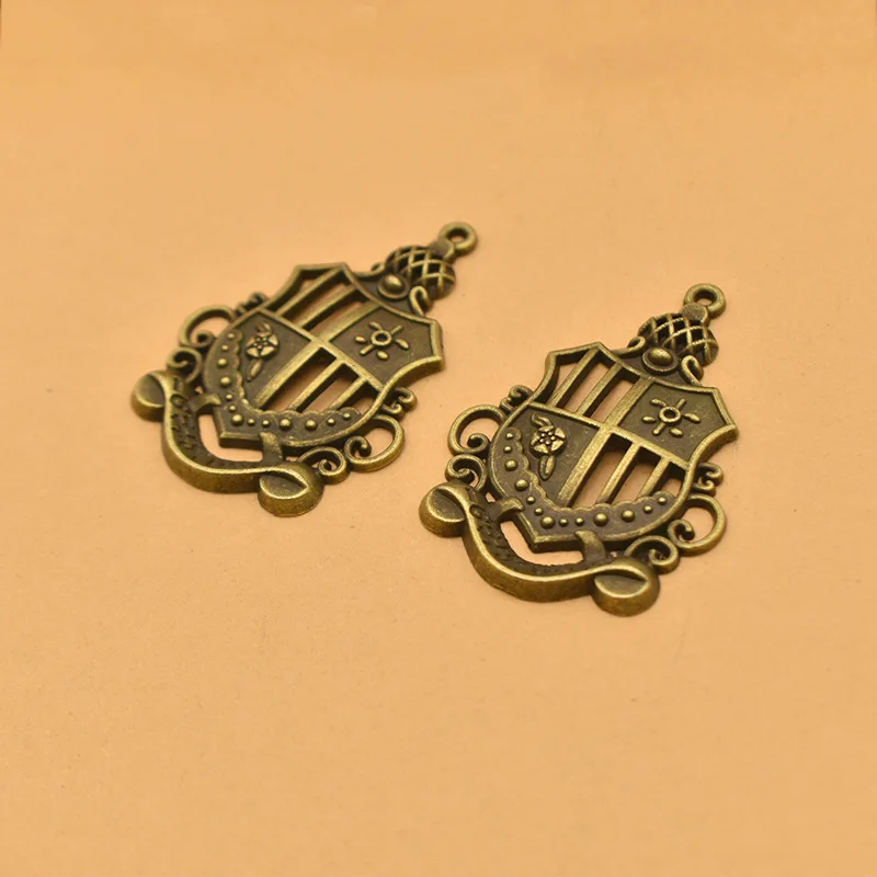 Unique and charming vintage style! Beautifully hollowed alloy crown pendant, badge, to complement your accessories!