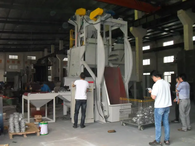 rubber belt tumble type shot blasting machine with automatic loading unloading system for for Sewing machine parts surface clean