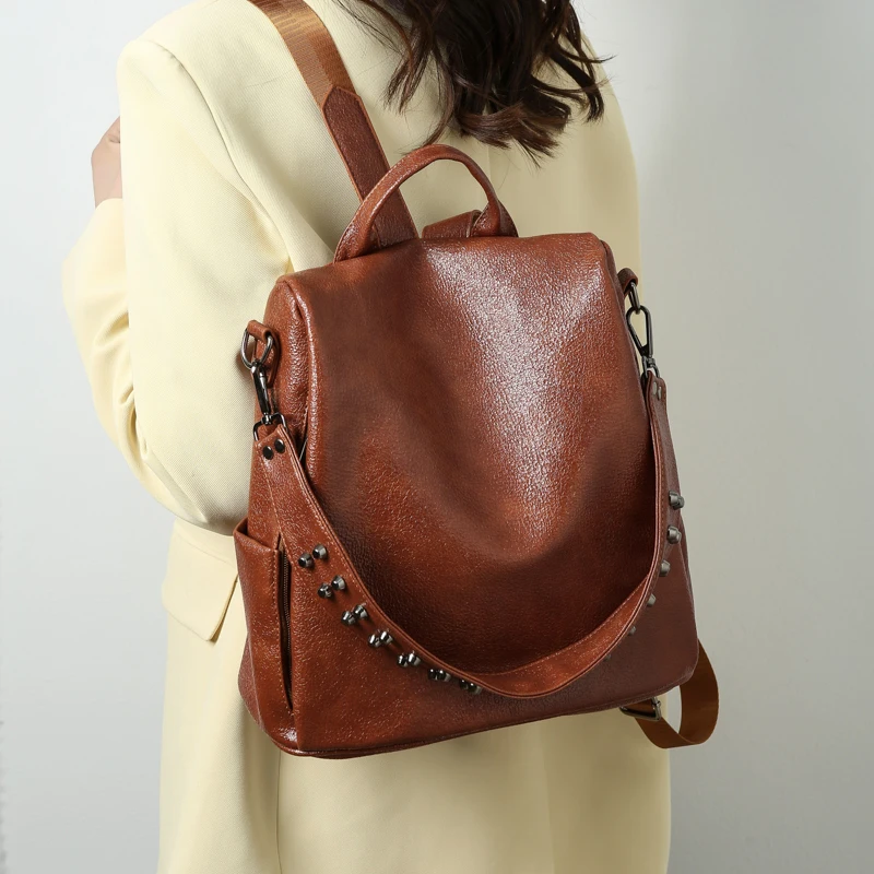 high quality soft PU leather wholesale young teenager casual backpack large capacity solid color backpack with rivet decoration