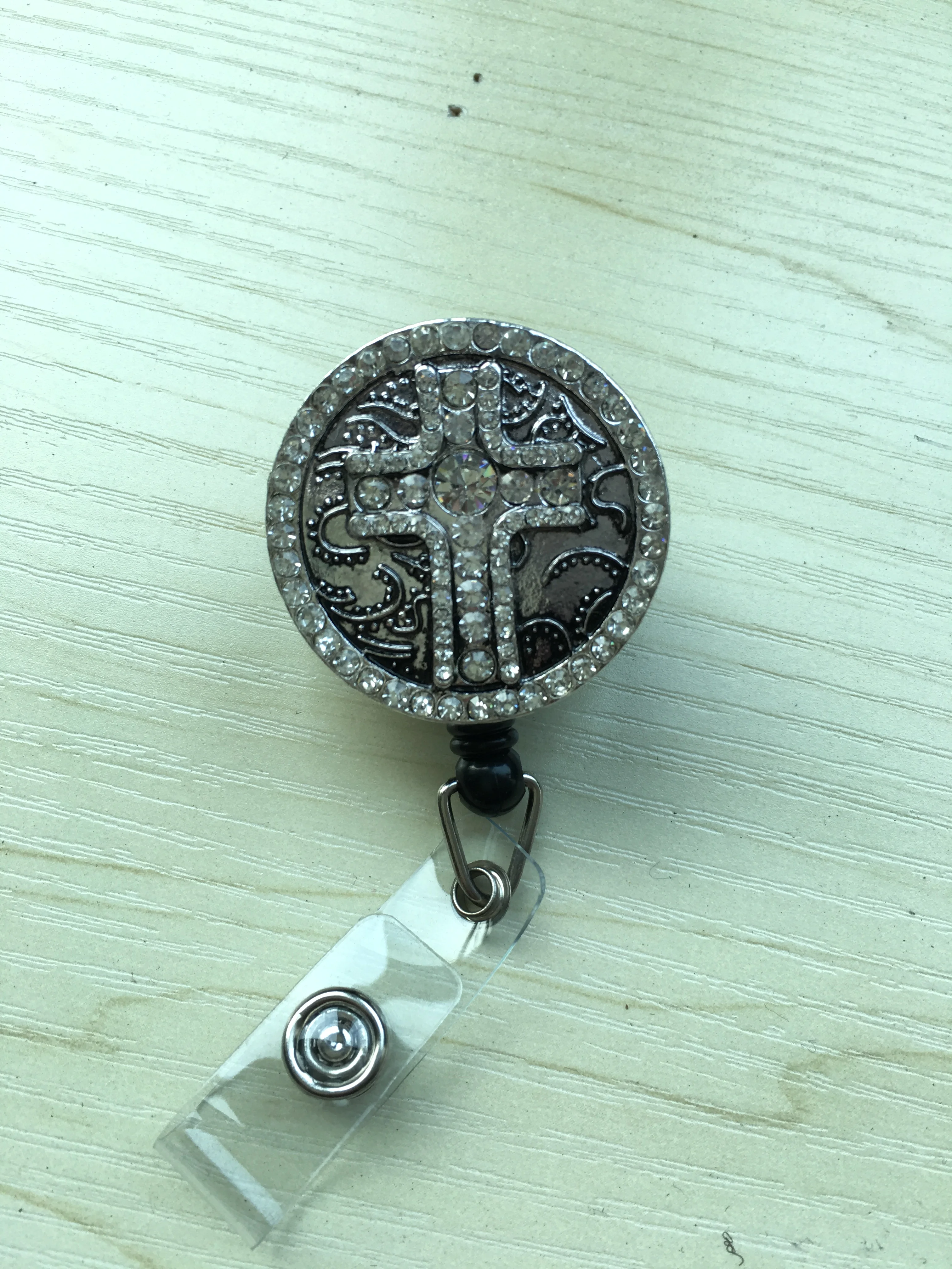 Retractable reel badge with breast cancer awareness logo