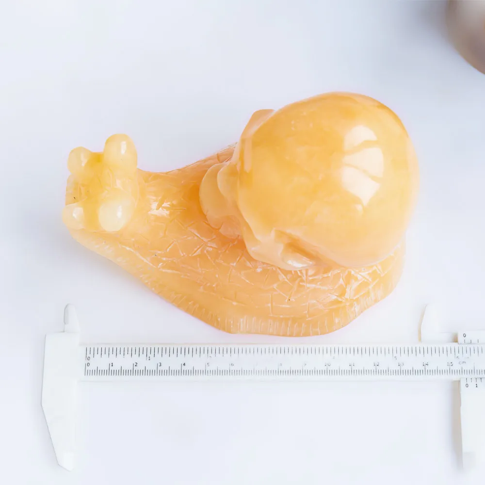 Wholesale hand carved natural healing stone pretty animal orange calcite crystal snail skulls folk crafts for home decoration