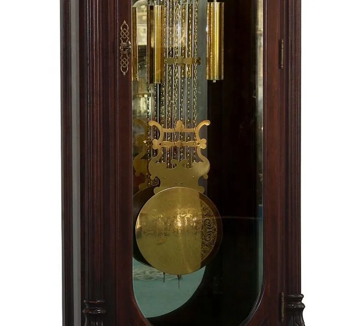 Floor Grandfather Clock door flanked by twin canted columns with turned top and bottom caps completing the traditional de