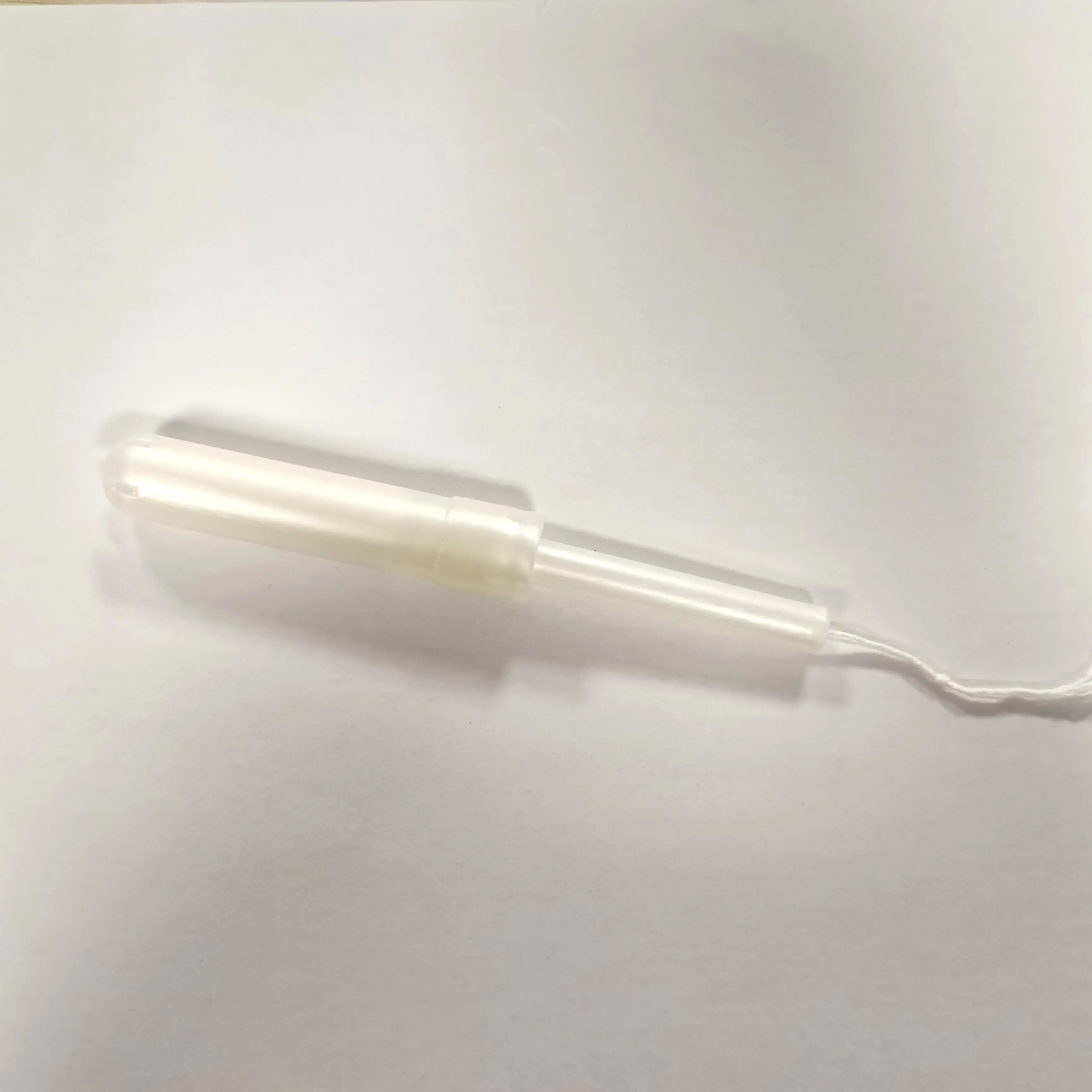 Disposable cotton tampons with plastic applicator