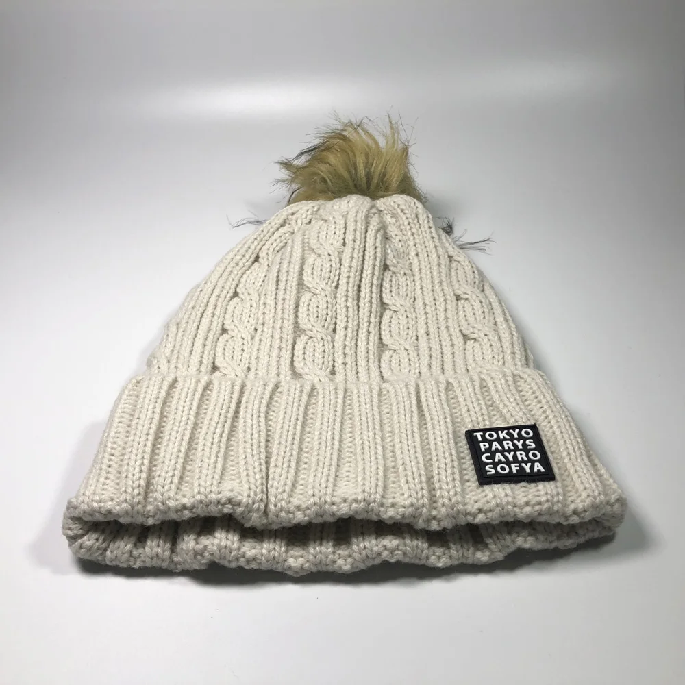 Women fashion beige faux fur pom pom skull bobble hats for children and adults Custom embroidery label acrylic cable knit beanie