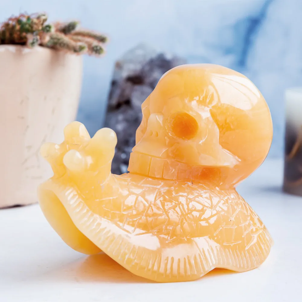 Wholesale hand carved natural healing stone pretty animal orange calcite crystal snail skulls folk crafts for home decoration