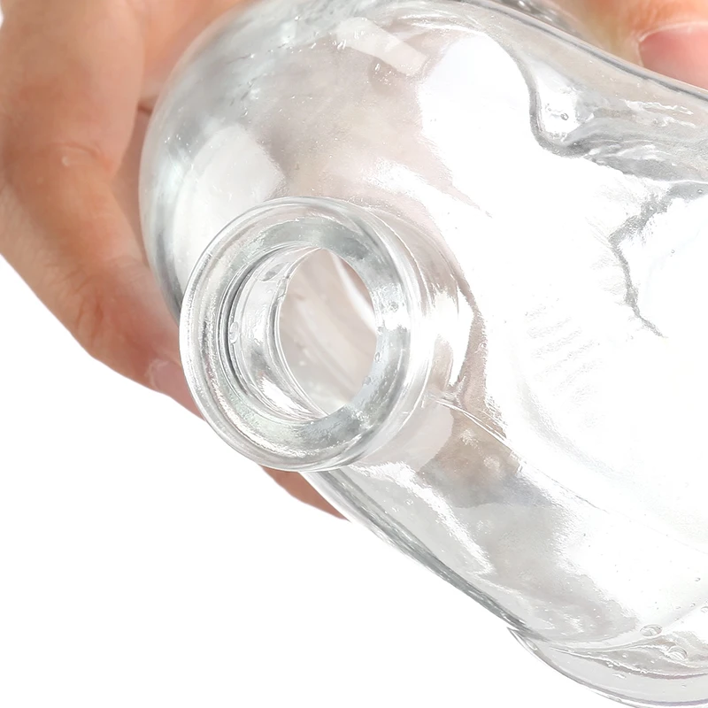 factory price high capacity hand model creative design 750ml transparent liquor glass bottle