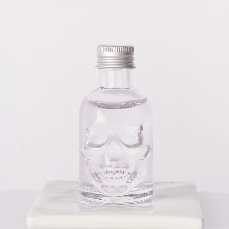 Wholesale 50ml Skull shape small sample alcoholic beverage bottle glass wine bottle with lids