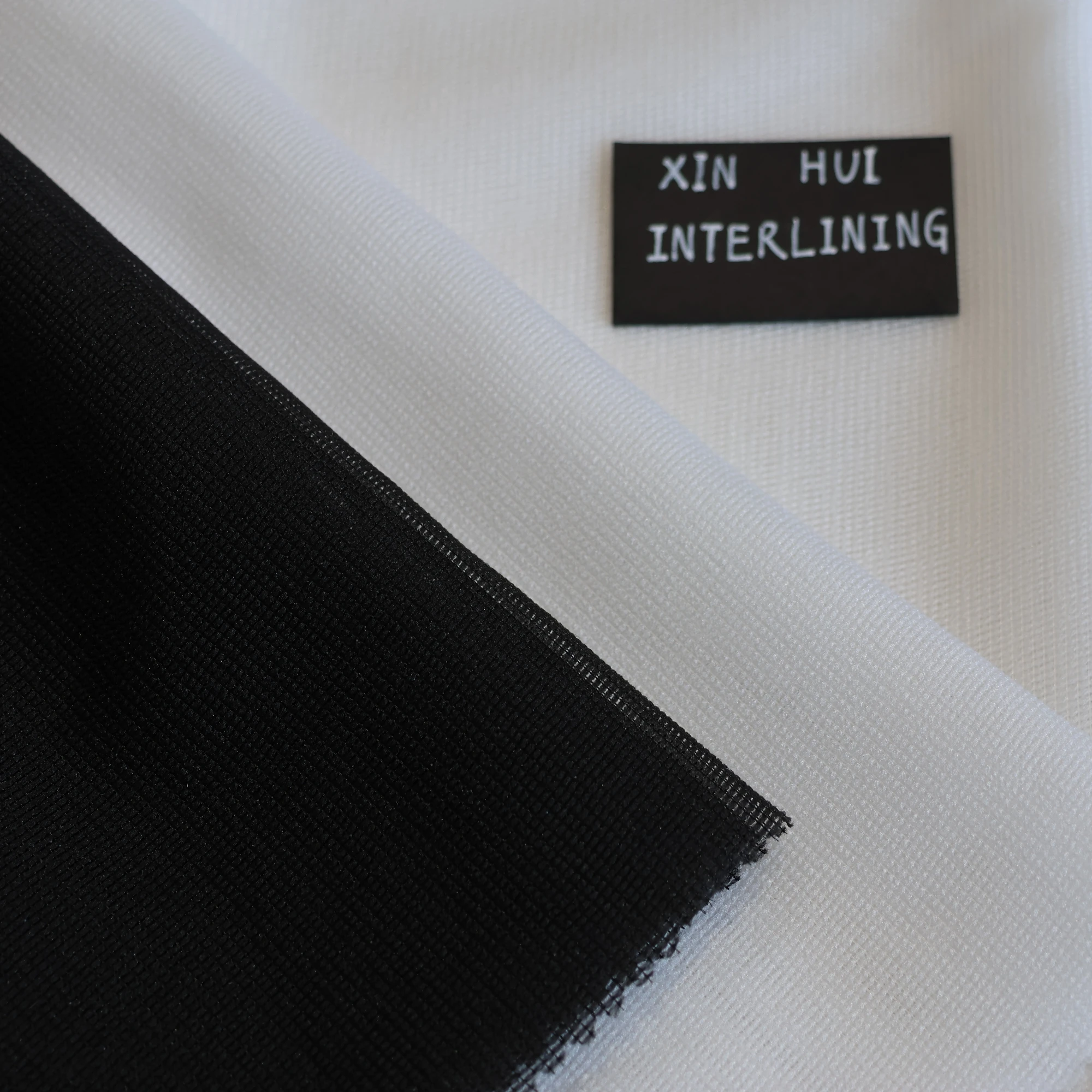 L/C support factory 100% Polyester Stretch Fusible Woven Warp Knitted Interlining