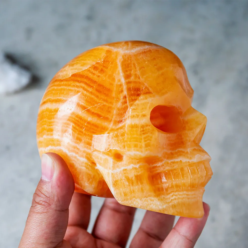 Wholesale Natural Reiki Gemstone Hand Carved Orange Calcite Crystal Skulls Crafts Healing Stone For Home Decoration
