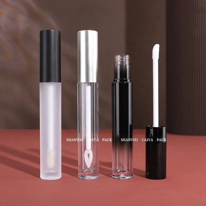Shantou cosmetic packaging manufacturer wholesale 3ml long neck empty frost black silver round lip gloss balm tube heart brush