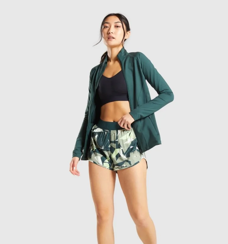 body fit nylon and spandex long sleeve high neck deep zipped pockets zip up ladies training sports athletic jacket women