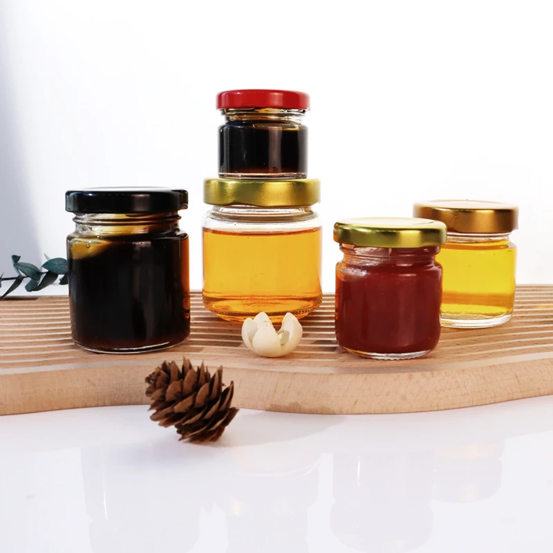 Wholesale Factory Price 25ml 50ml 100ml Mini Glass Jam Honey Jar Custom Logo Canned Food Storage Container with Metal Screw Lid