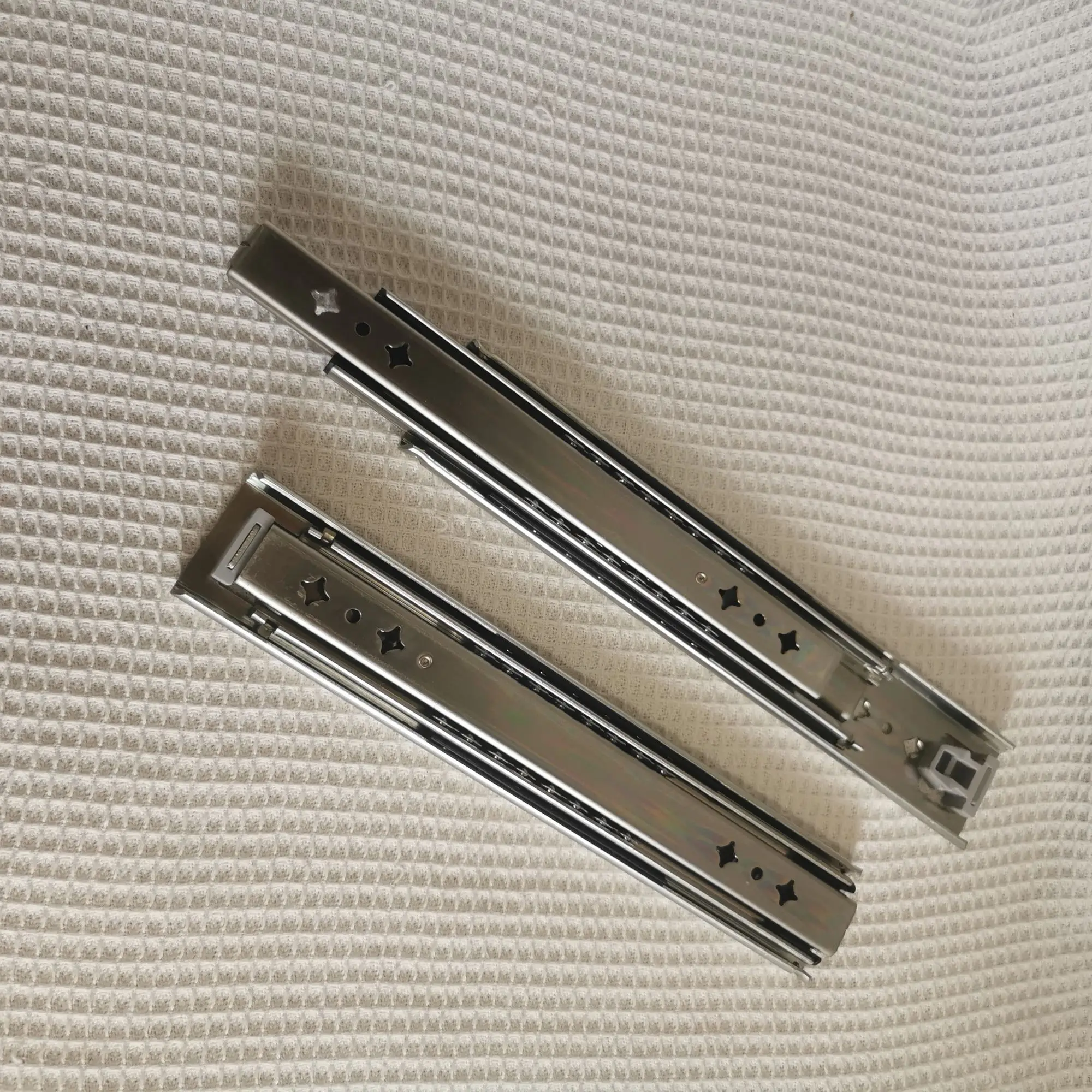 Hidden drawer slides are installed at the bottom of the heavy-duty drawer rails under the stairs