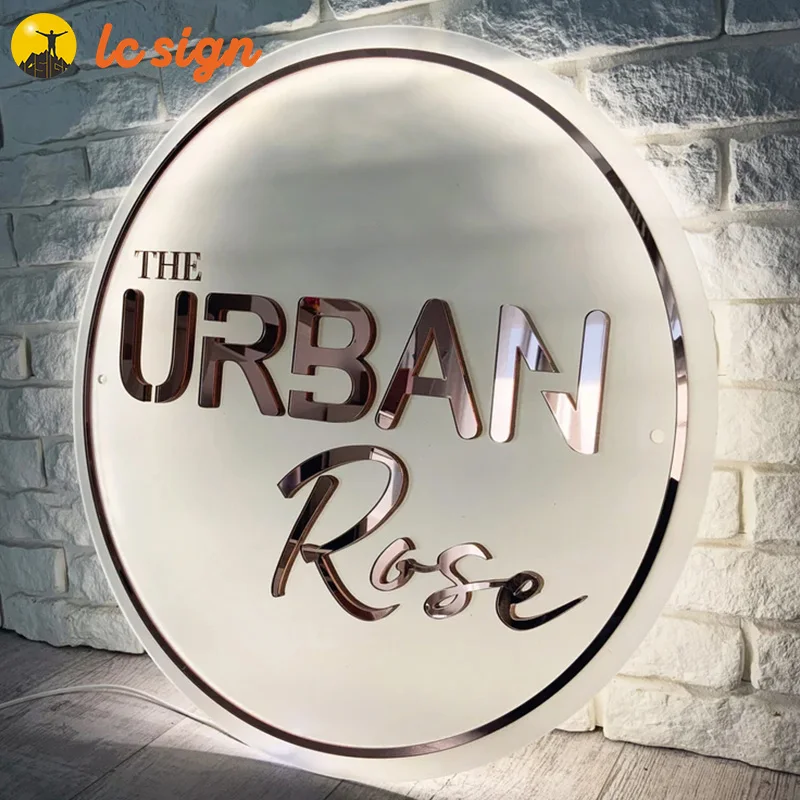 Acrylic white logo with LED light. Golden mirror letters, business signs for beauty salon, boutique, barber shop
