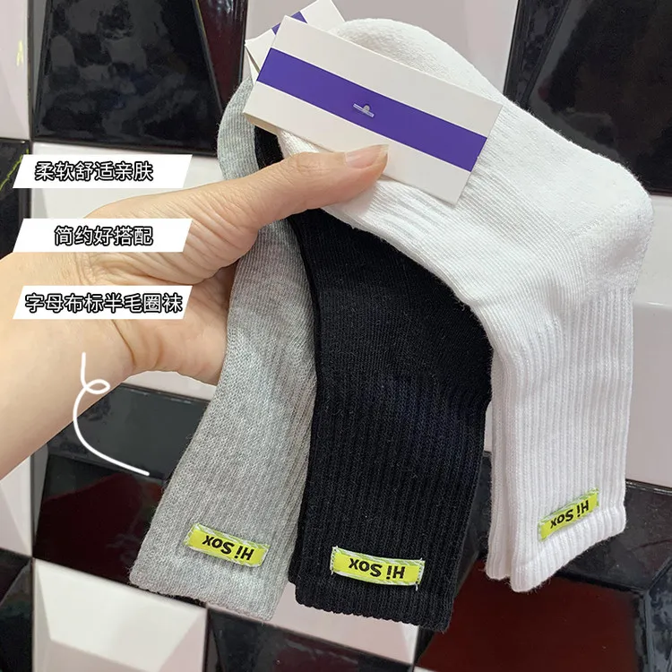 Hot selling cotton children long socks custom logo fashion comfortable school black white grey kids with phrases terry socks