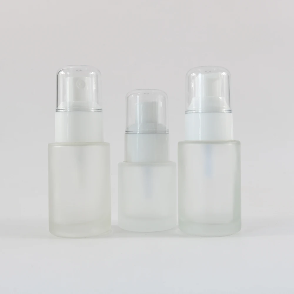Cosmetic clear frosted glass flat shoulder bottle with white white pump
