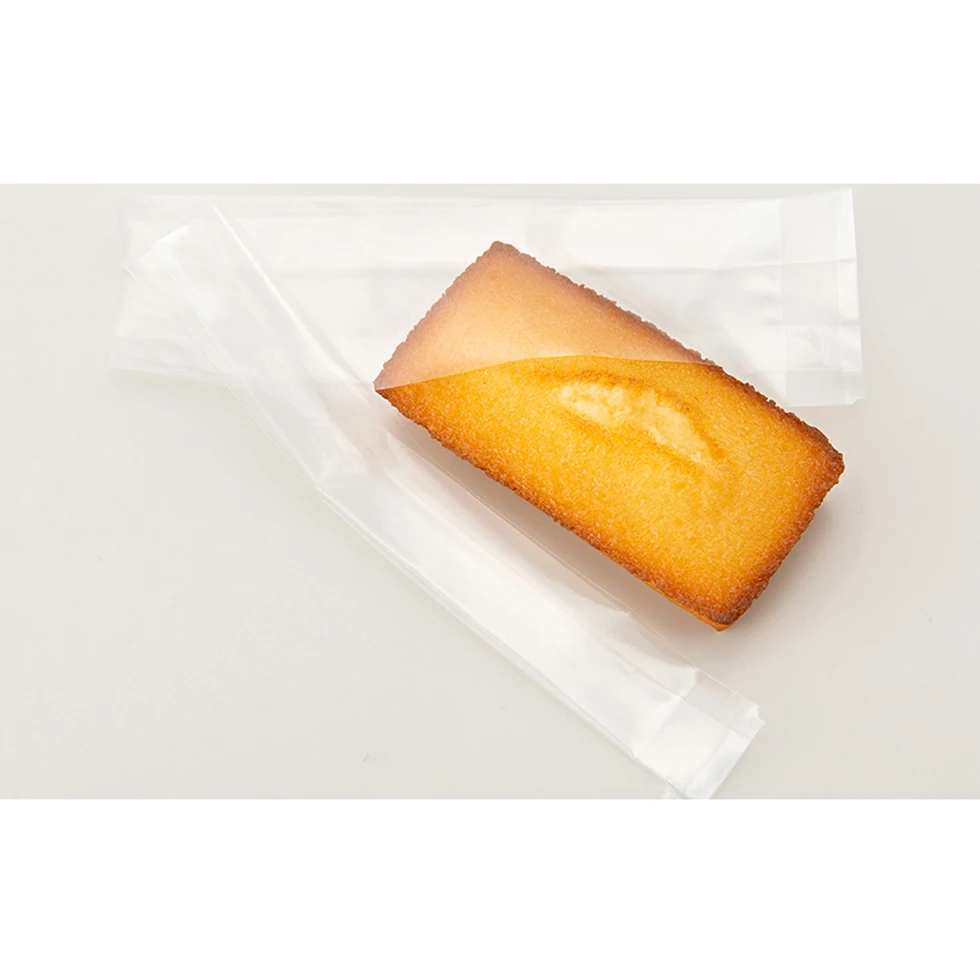 Linear tear straight cut stretch film for easy open retort pouch