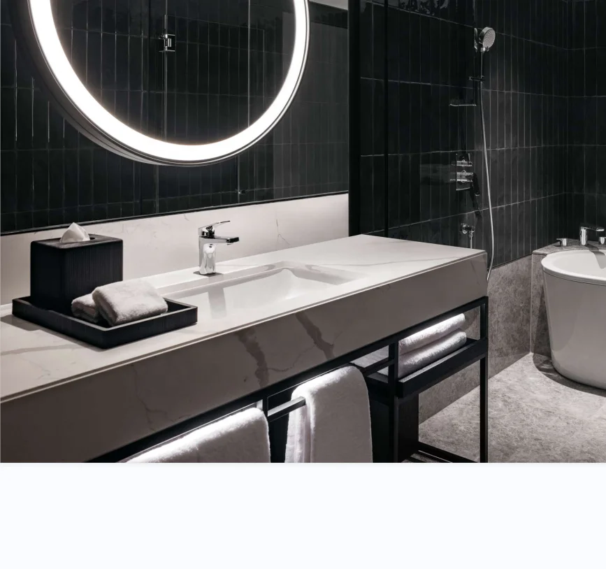Double wood vanity include matte black faucets and oval mirrors soft blue tile and freestanding bath welcomes relaxation