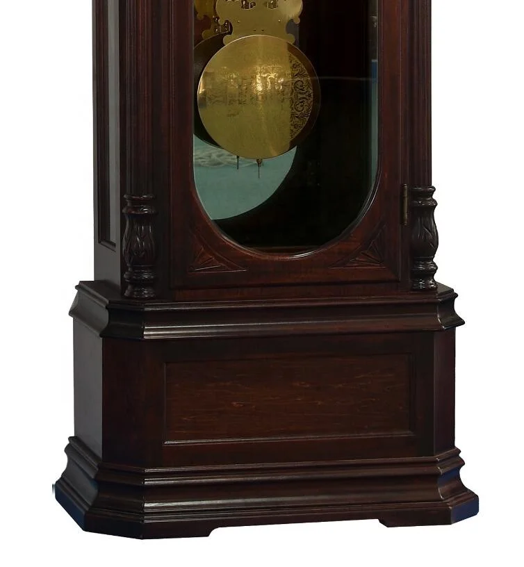 Floor Grandfather Clock door flanked by twin canted columns with turned top and bottom caps completing the traditional de