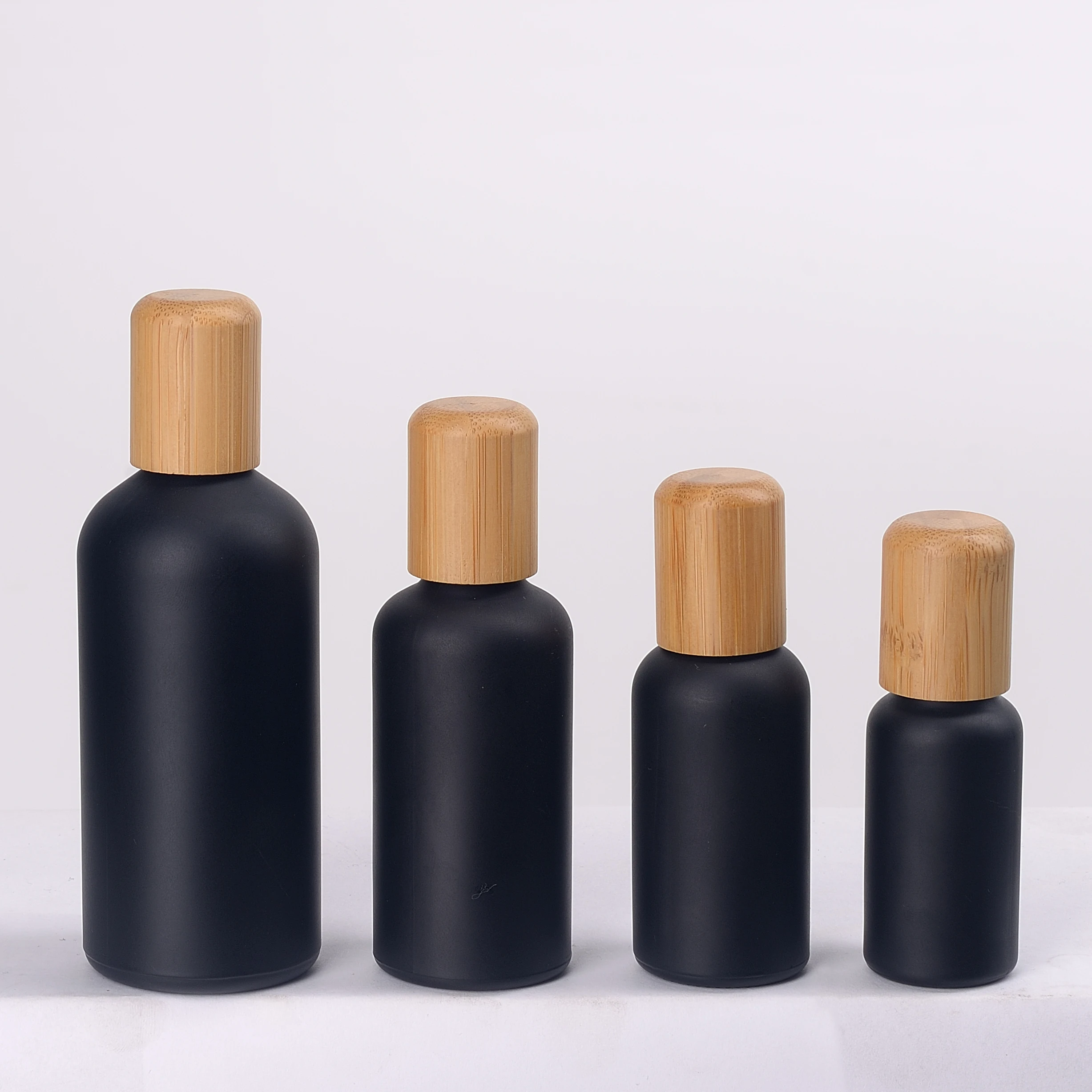 matte black glass bottles 100 ml glass essential oil bottles with 18 mm bamboo lid and drip plug for body massage oil