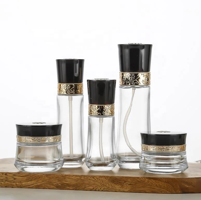 Luxury cosmetic packaging container clear glass packaging bottle with carved cover