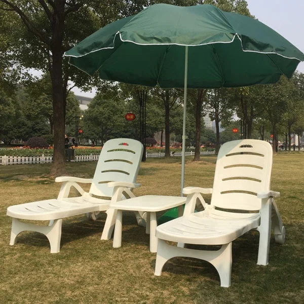 Outdoor beach hotel swimming pool plastic chaise lounge chair