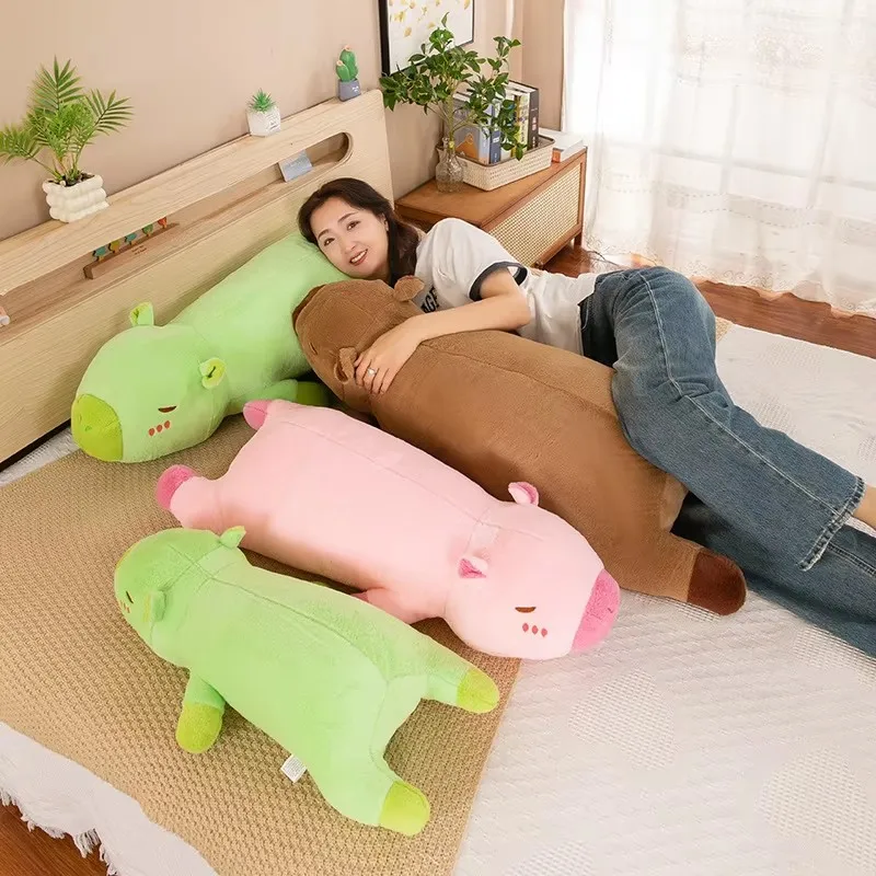 The capybara pulls the pillow for girls to sleep on the bed and holds the sleeping doll long pillow plush toy