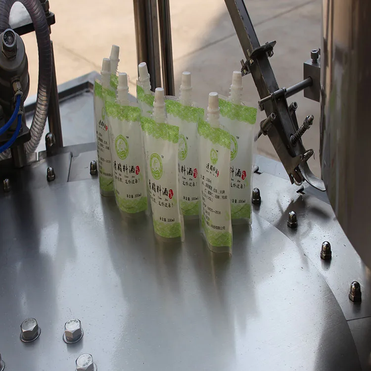 Rotary Automatic Premade Spout Bag Doypack Suck Pouches Filler Drink Milk Filling Capping Machine For Liquid Juice
