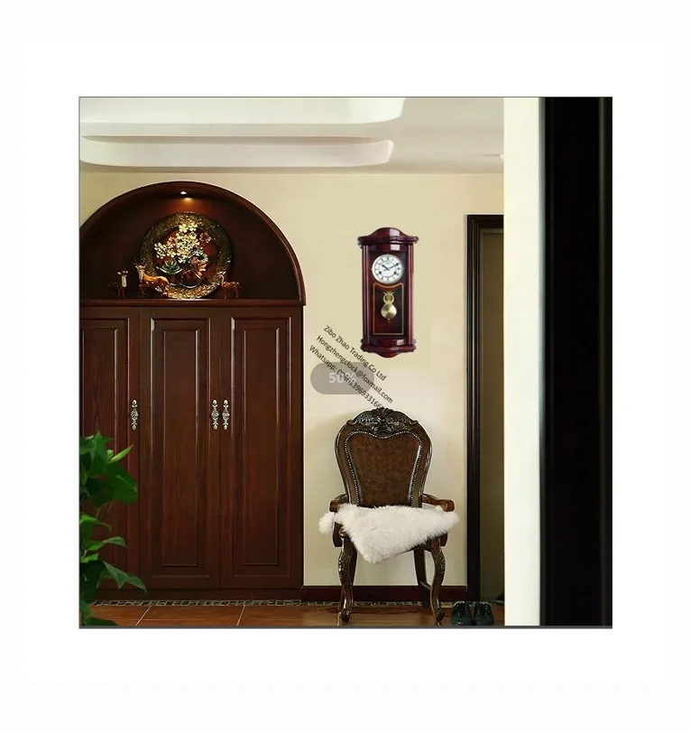 Wood Pendulum Wall Clock An understated regulator clock with dark wood case, a pressed metal dial and chapter ring