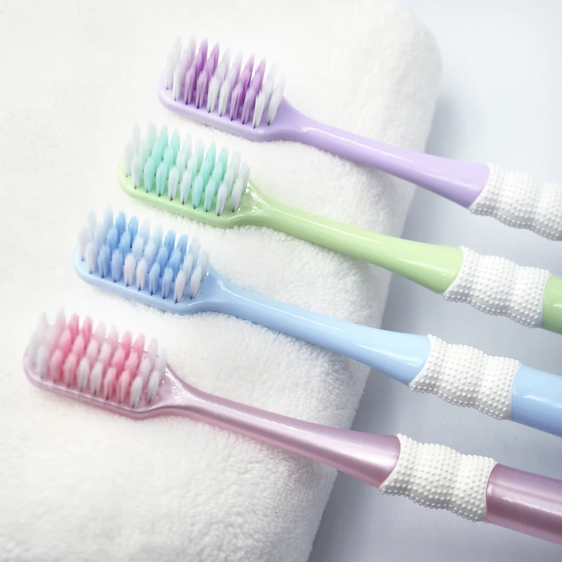 Factory wholesale custom logo shaped hole bristles plastic adult toothbrush